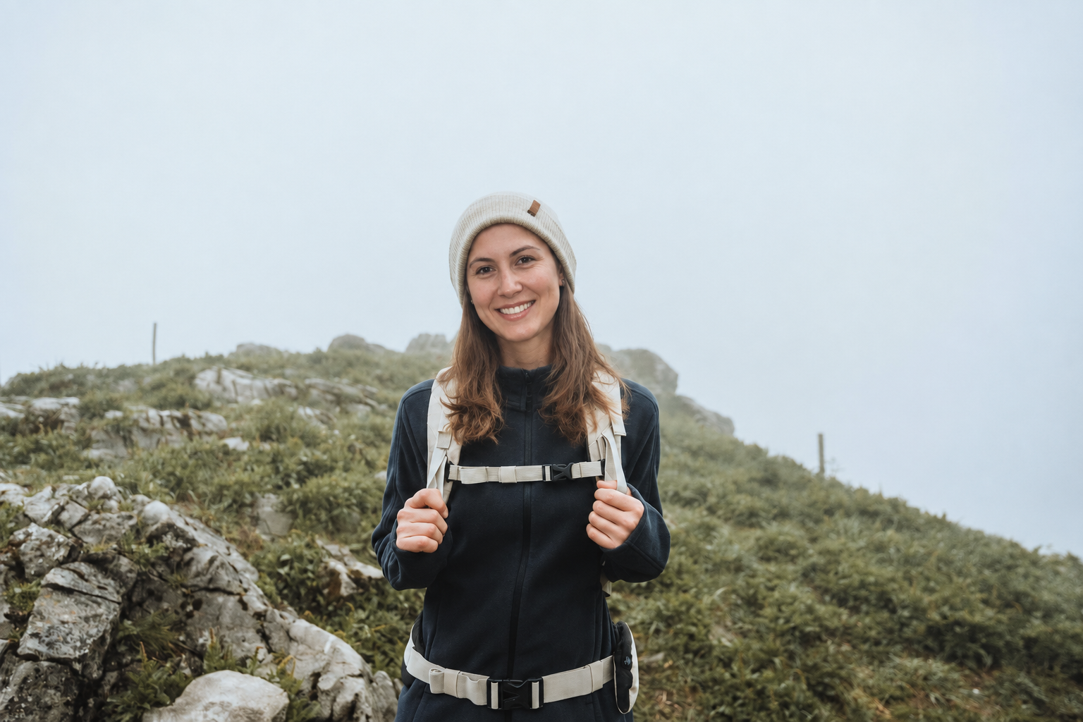 Rowan with a backpack on a misty hillside